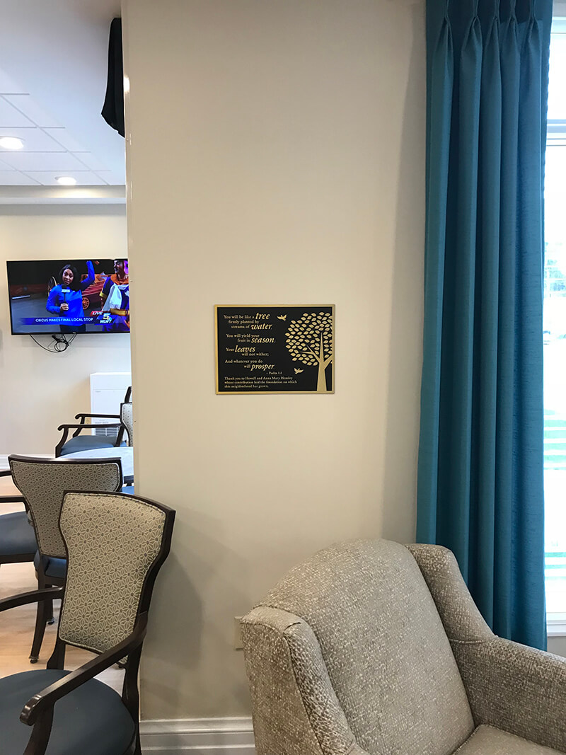 Giving tree custom decal on the wall with furniture on the side