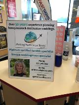 Custom wayfinding signage on the table of the store with fast sign feather flag on the back