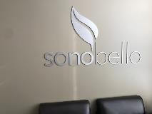 Sonobello logo on the wall with black chair on the front 