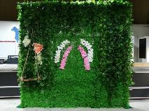 Grass pop up display with pink and white design inside the building