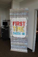 First time banner with design in the corner with computer in the background