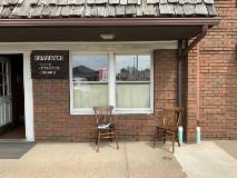 Briarpatch Signage with chair outside the store