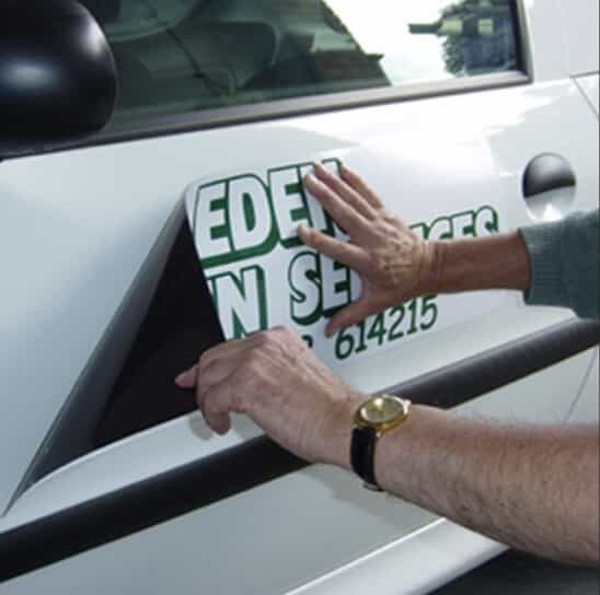 a magnetic sign is applied to a car