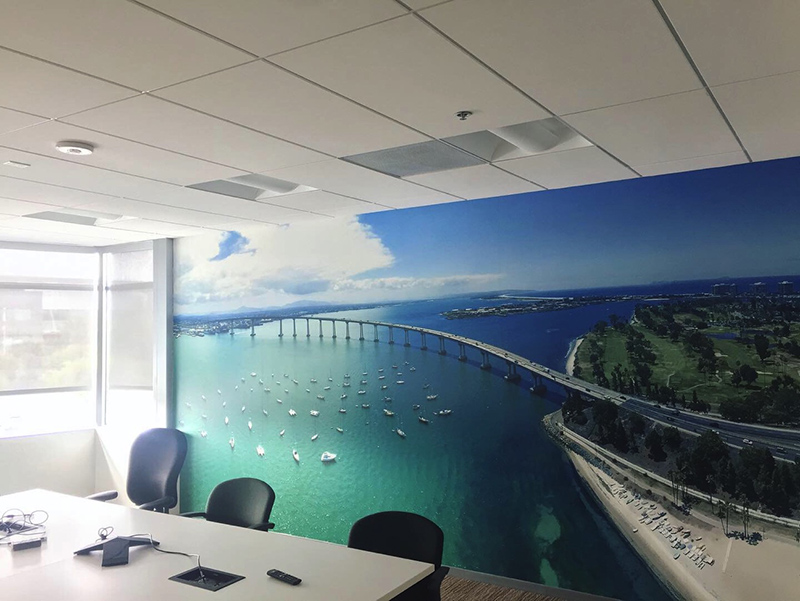 a wall mural shows an image of an ocean next to a city
