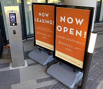 temporary signage for a new luxury apartment complex now open