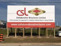 Collaborative structure signage on a lot with car and building on the side