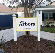 The social arbors signage in front of the tree