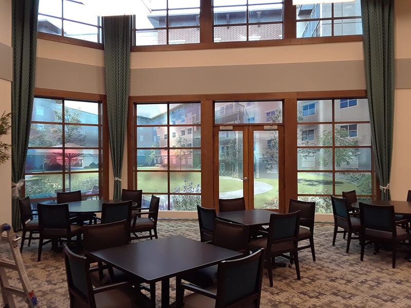 The Carrington at Lincolnwood lobby with lettering on the door and chair and tables