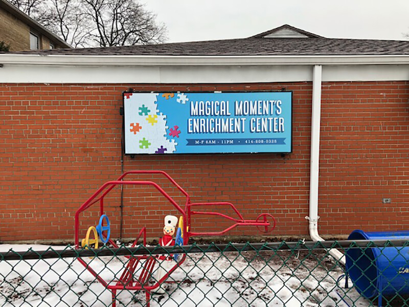 Magical Moments blue banner  outside the building wall