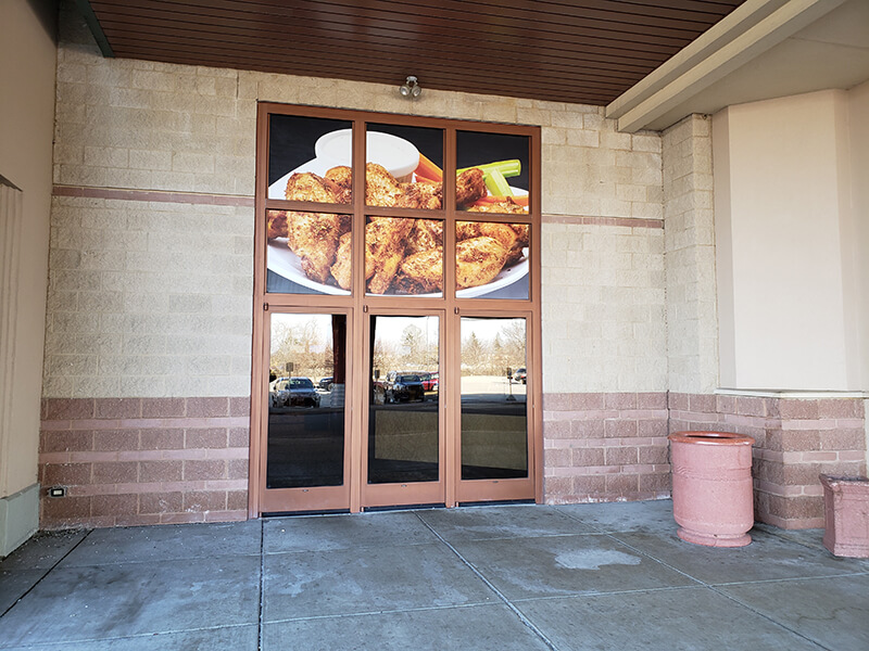 Food image on the glass window of the building