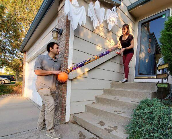 Couple holding a trick or treat stick for decoration