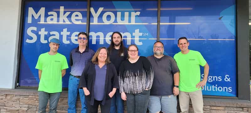 A group photo of the staff. From left to right: Joshua Spiceland, Greg Metcalf, Judy Kaylor, Eli Smith, Nikki Swafford, John Fiddner, and Toby Schaedler.