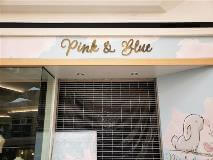 Pink and blue custom signage on the building