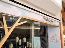 Pink and blue custom signage on the store