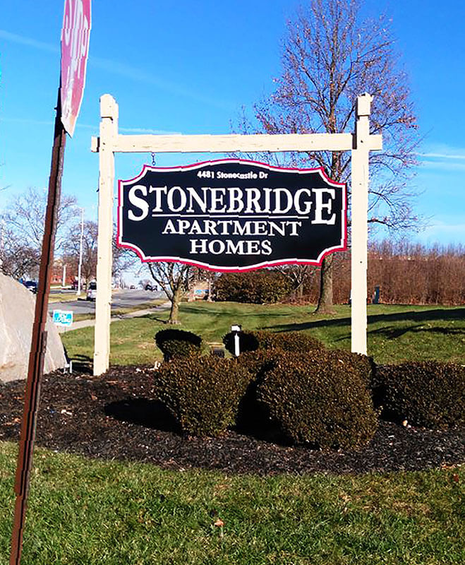 Stonebridge apartment homes signage on a lot with plants 