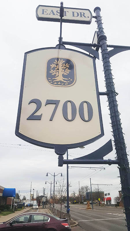 2700 signage on the pole along the street with car