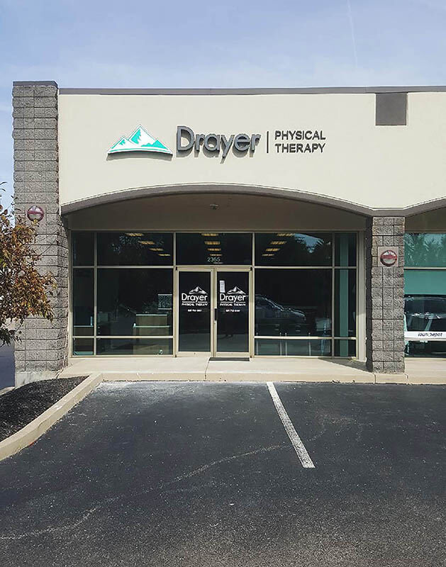 Drayer Physical therapy signage on the building with trees on the side