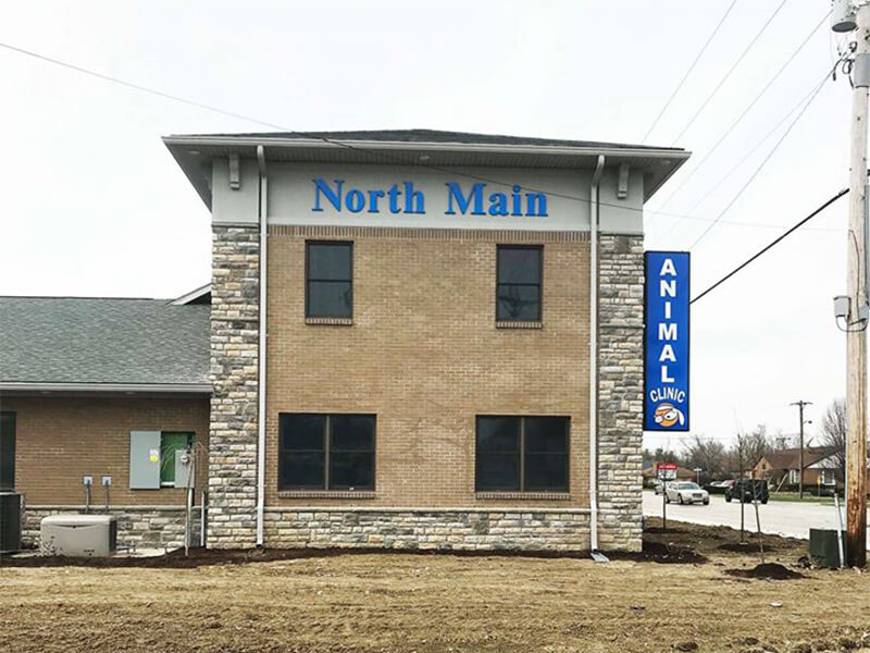 North Main Animal Clinic signage on the building  with electrical post on the side