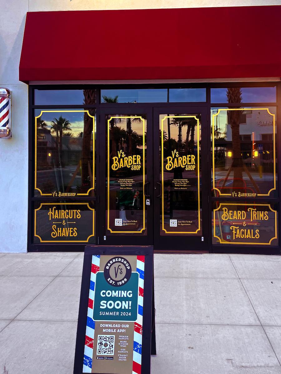 An image of a coming soon barbershop with all of its signage.