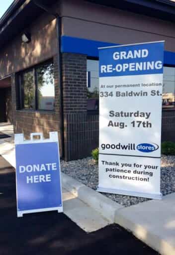 A large banner and a-frame indicate a grand re opening