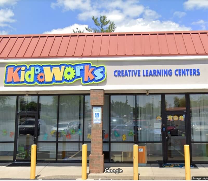 Colorful kidworks signage on the building with red roof