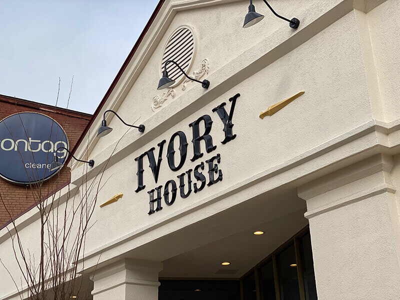 Ivory House signage on the white building with lights