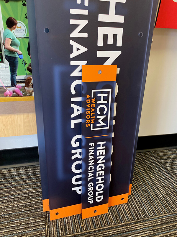 HCM AV Group decals with blue theme on the carpeted  floor 