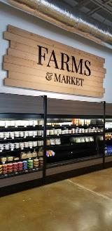 Farms & market signage on the store with products below the sign