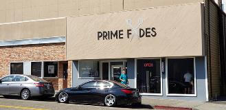 Prime Fides sign on the store with cars parked