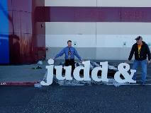 Judd & Signage with two man posing for a picture
