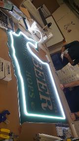 Washington Beer & hops signage worked by an employee