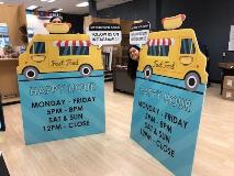 Promotional board on display with a woman 