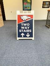 Two way stairs frame sign along the school hallway
