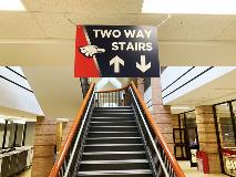 Two way stairs hanging sign above the stairs