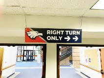 Right turn only hanging sign on the school hallway