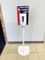Sanitize hands signage on the wall with soap dispenser