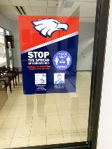 Stop COVID awareness sign  on the glass window