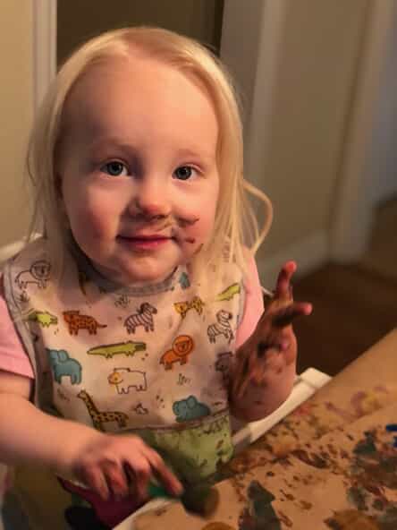 hayden with paint on her hands and face