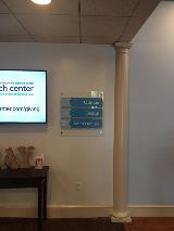 Blue Wayfinding sign with television on the wall