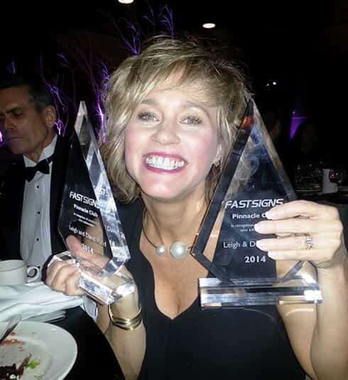 Leigh Rand poses with Pinnacle awards