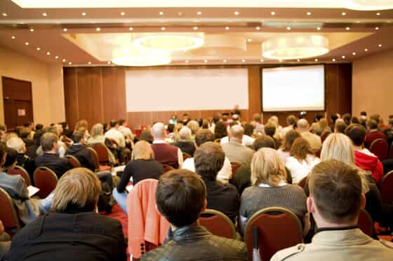 an audience listening to a presentation