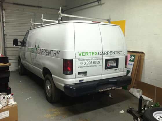 a van wrapped in graphics for the vertex brand