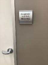 Mailroom shipping receiving sign on the door