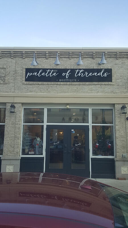 The palette of threads Signage on the store with red car on the front