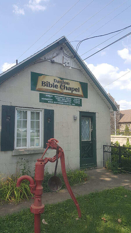 Chapel custom signage on the chapel with old red water pump