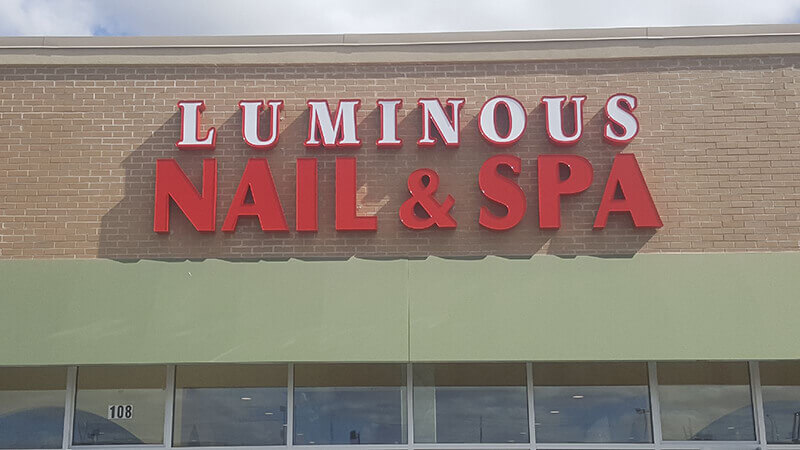 Luminous Nail and spa signage on the building