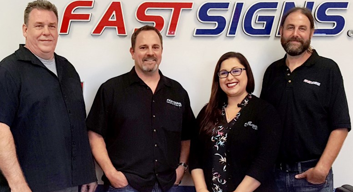 New Owners of the Daytona Beach FASTSIGNS® Celebrate Ribbon Cutting