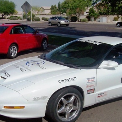 White car with custom car wraps on parking lot