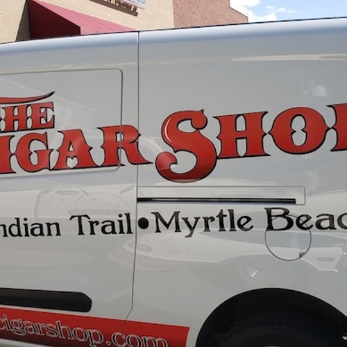 The Cigar shop van with graphics on parked