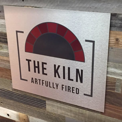 White custom decal of the Kiln on the wood wall